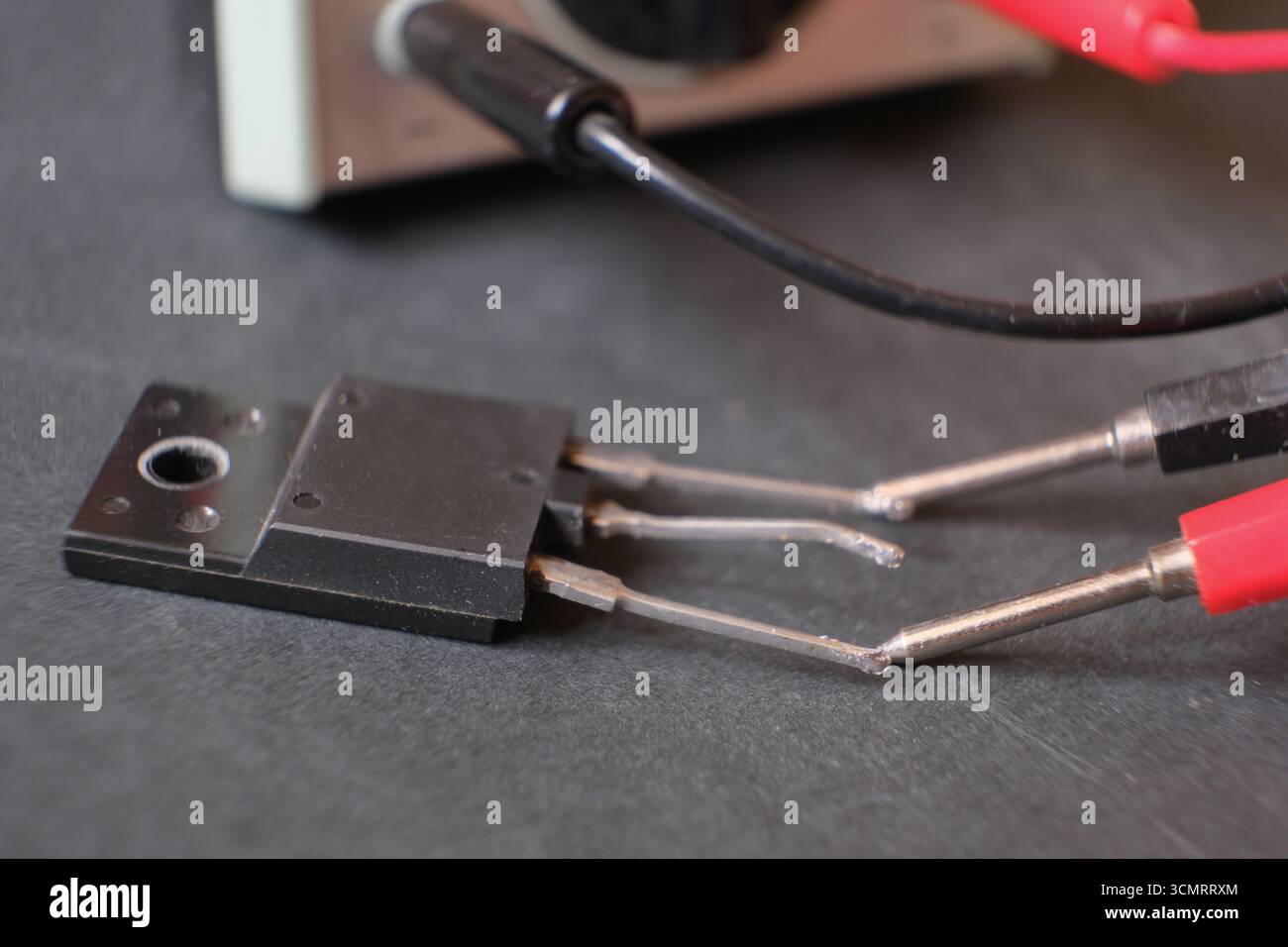 Transistor. A power transistor testing with the multimeter Stock Photo