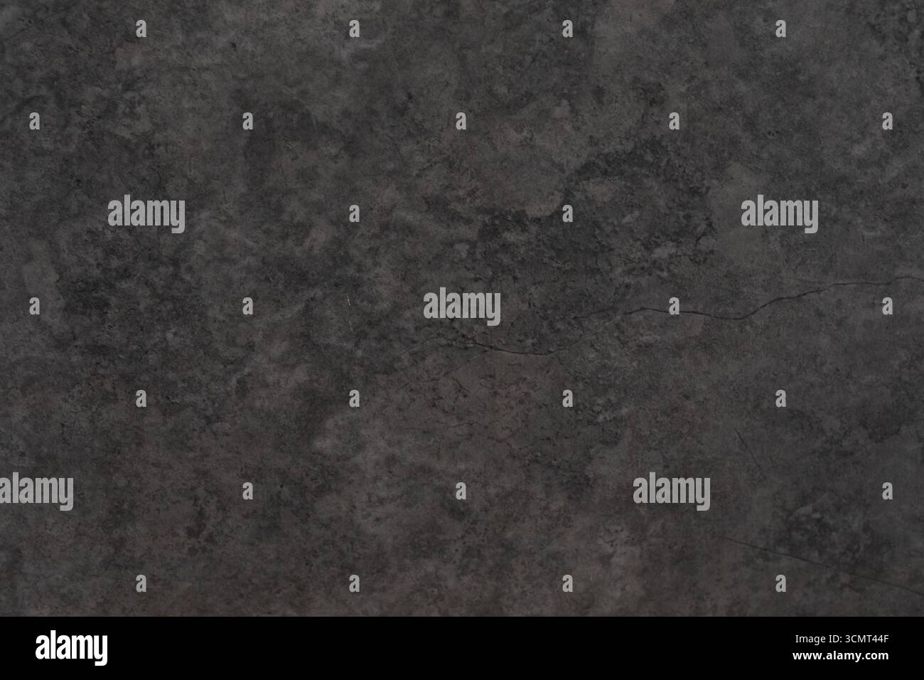 Dark textured surface with subtle patterns and a crack highlights the ...