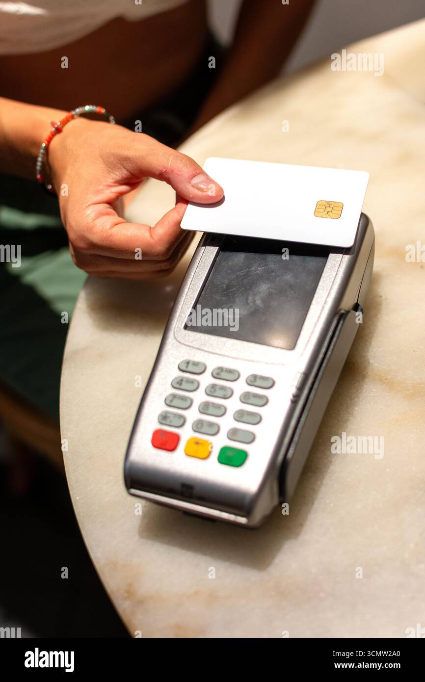 Client using contactless payment technology with credit card on pos ...