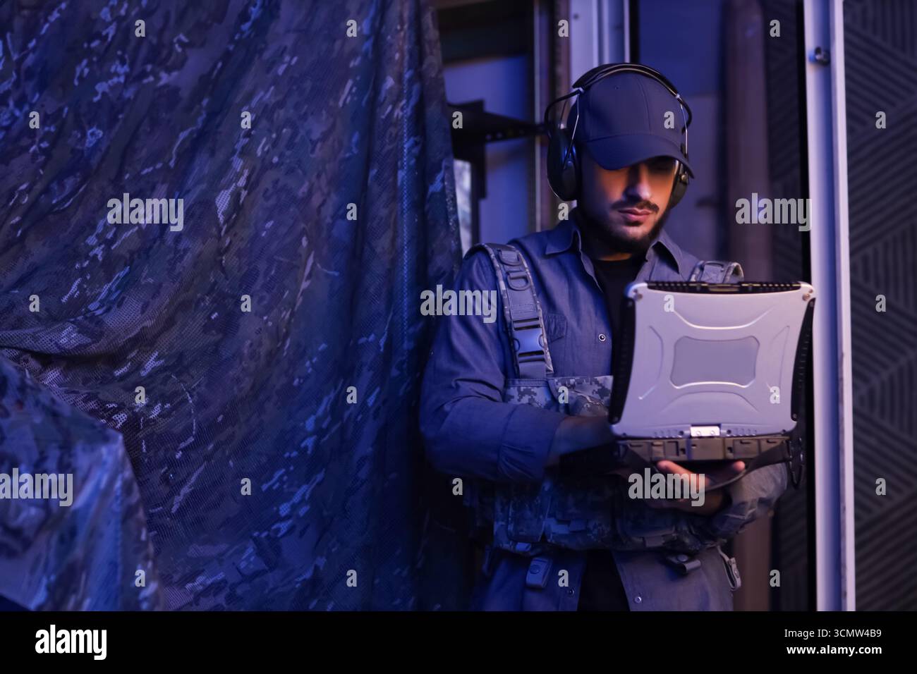 Soldier working with military laptop in command center at night Stock ...