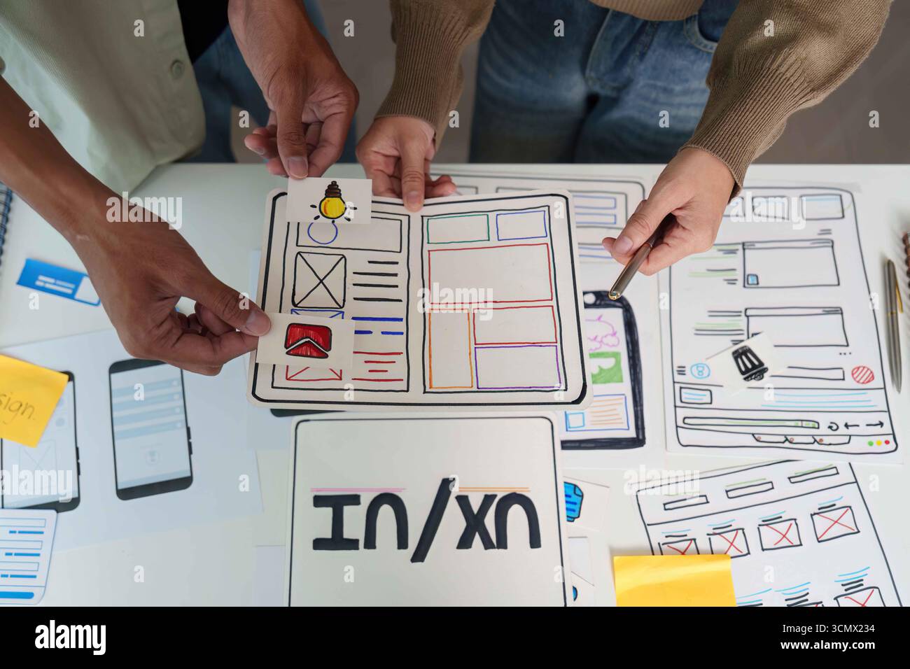 UX UI Design Review. Team evaluating user interface designs and feedback. Stock Photo