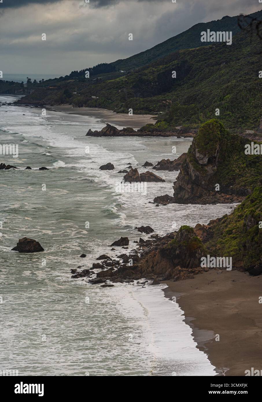 Off Shore Rocks Curving Shoreline with Offshore Rocks and Bush-Covered Cliffs Under ...