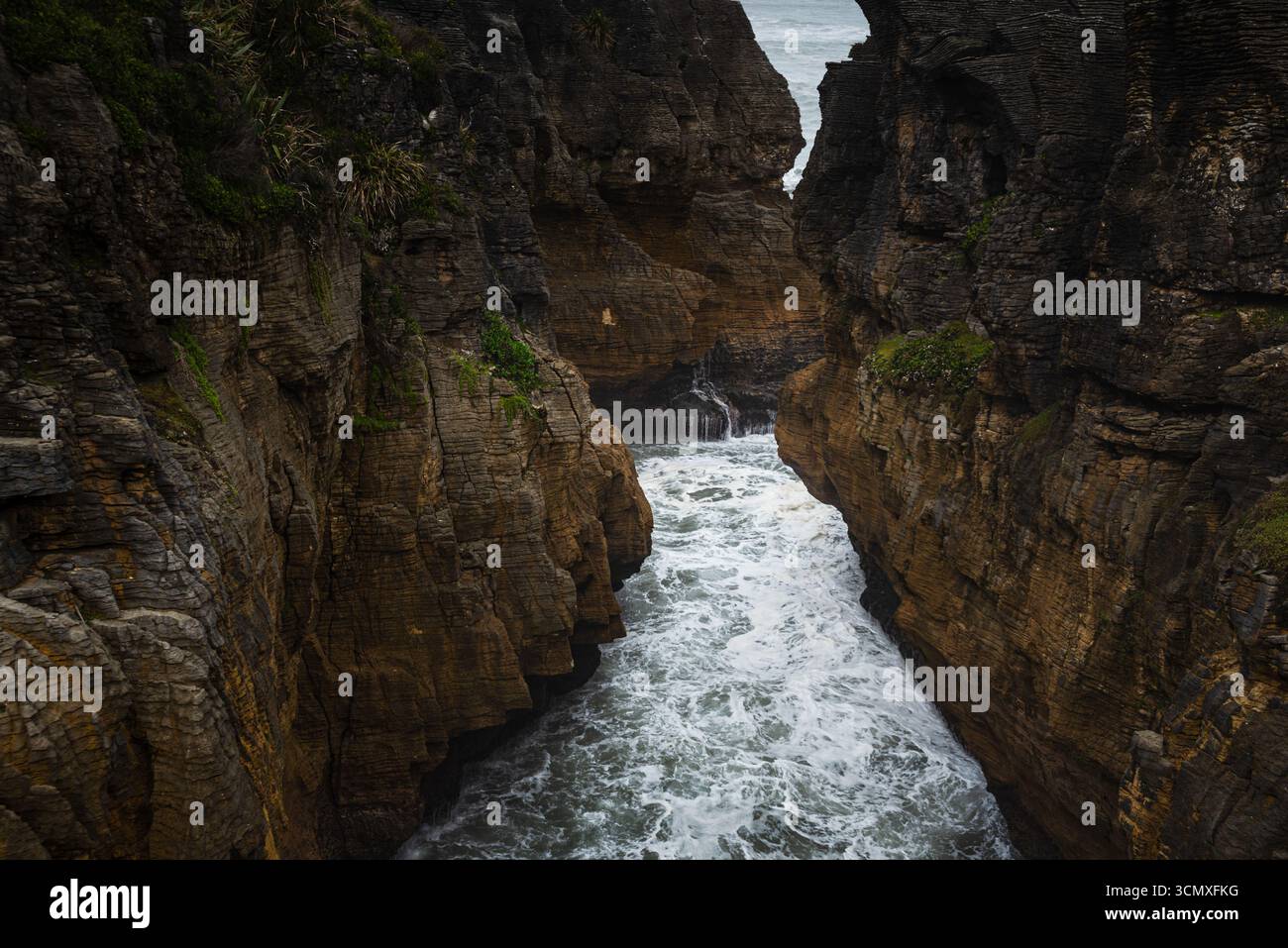 Narrow Chasm with Surging Ocean Waves Between Sheer Cliffs at Pancake ...