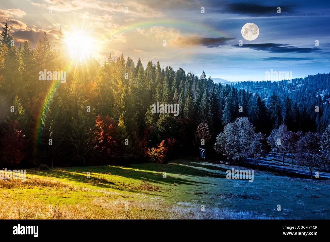 autumn equinox landscape with road through valley near forest with colorful trees. day and night time change concept. beautiful countryside scene in m Stock Photo