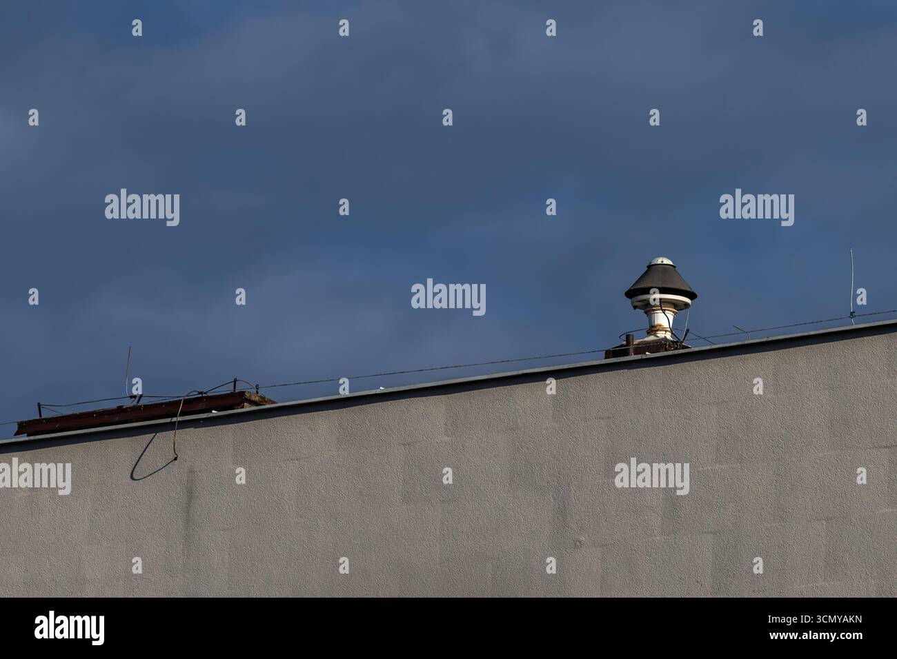 An alarm siren mounted on the roof of a building, the siren emits a signal warning of an air raid in Poland Stock Photo