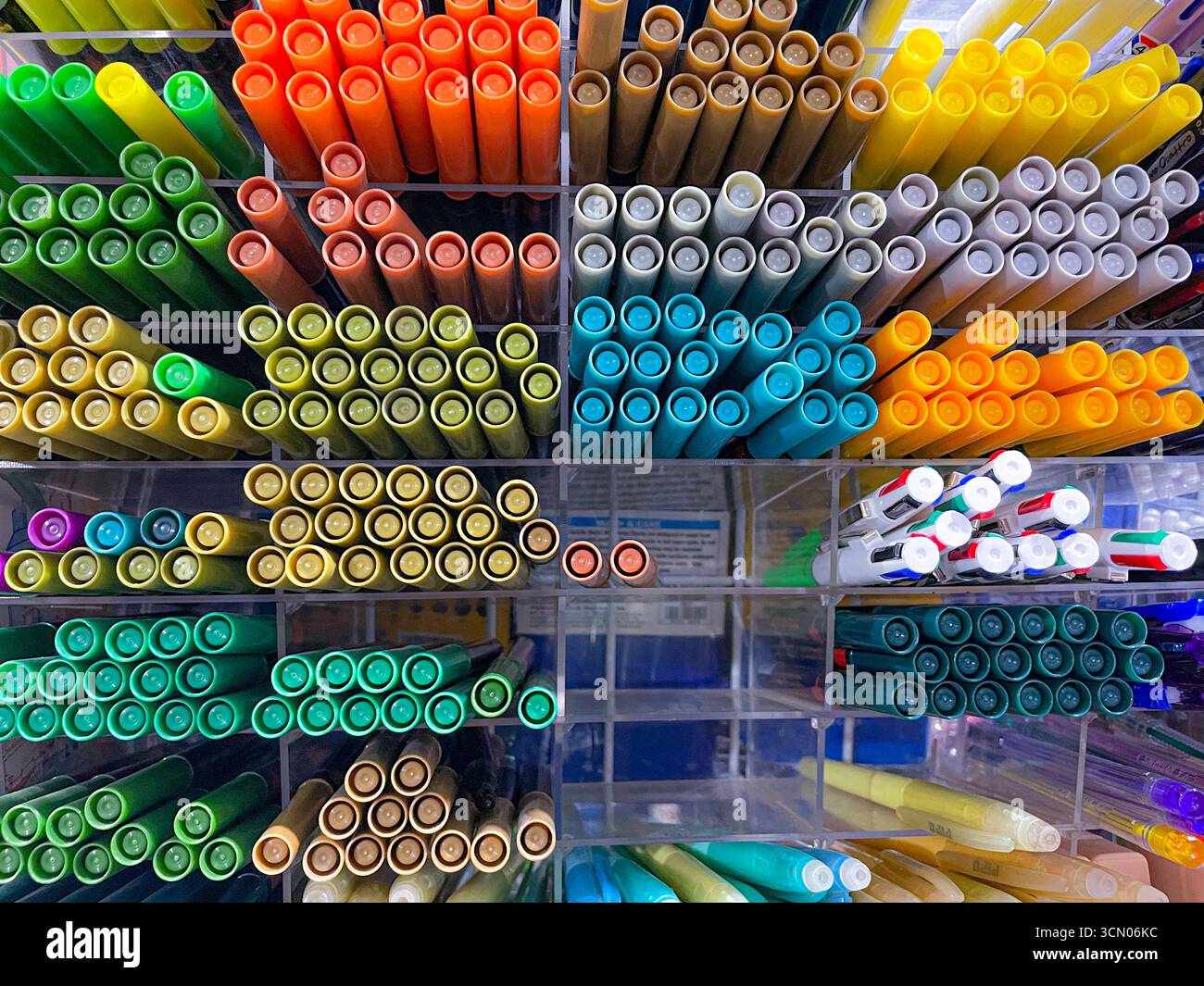 variety of pens and colors are neatly arranged on the stationery rack displayed in the shop for sale - Smartphone Captured Stock Image