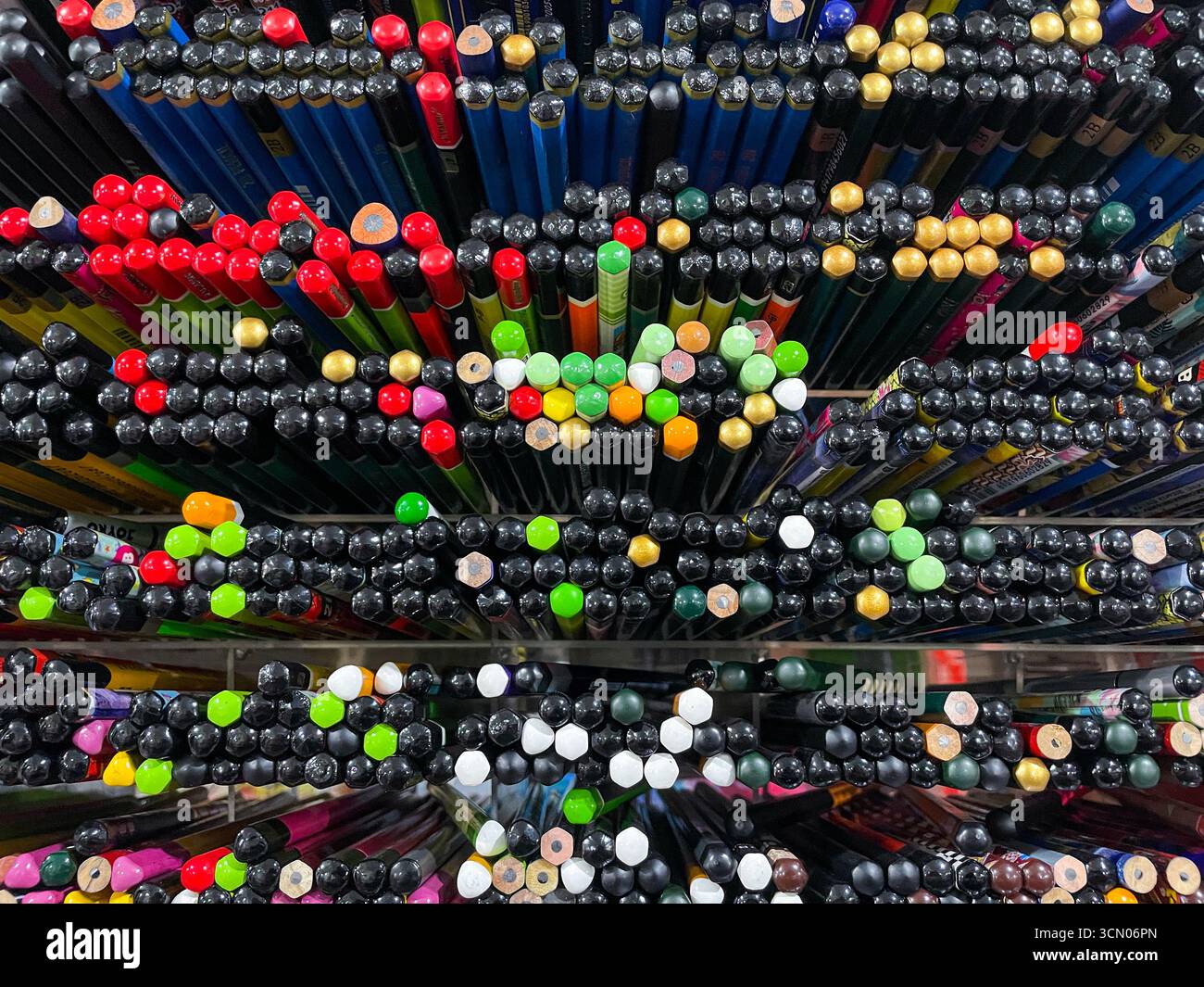 A neat arrangement of pencils of various types and sizes on the stationery store for sale - Smartphone Captured Stock Image