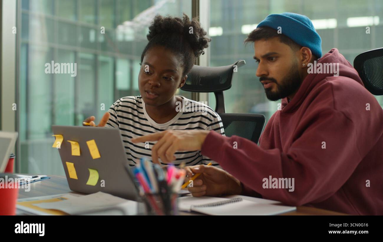 Multi-Ethnic entrepreneurs of informal business startup in office meeting diverse team work process in company workgroup, African American woman talk Stock Photo