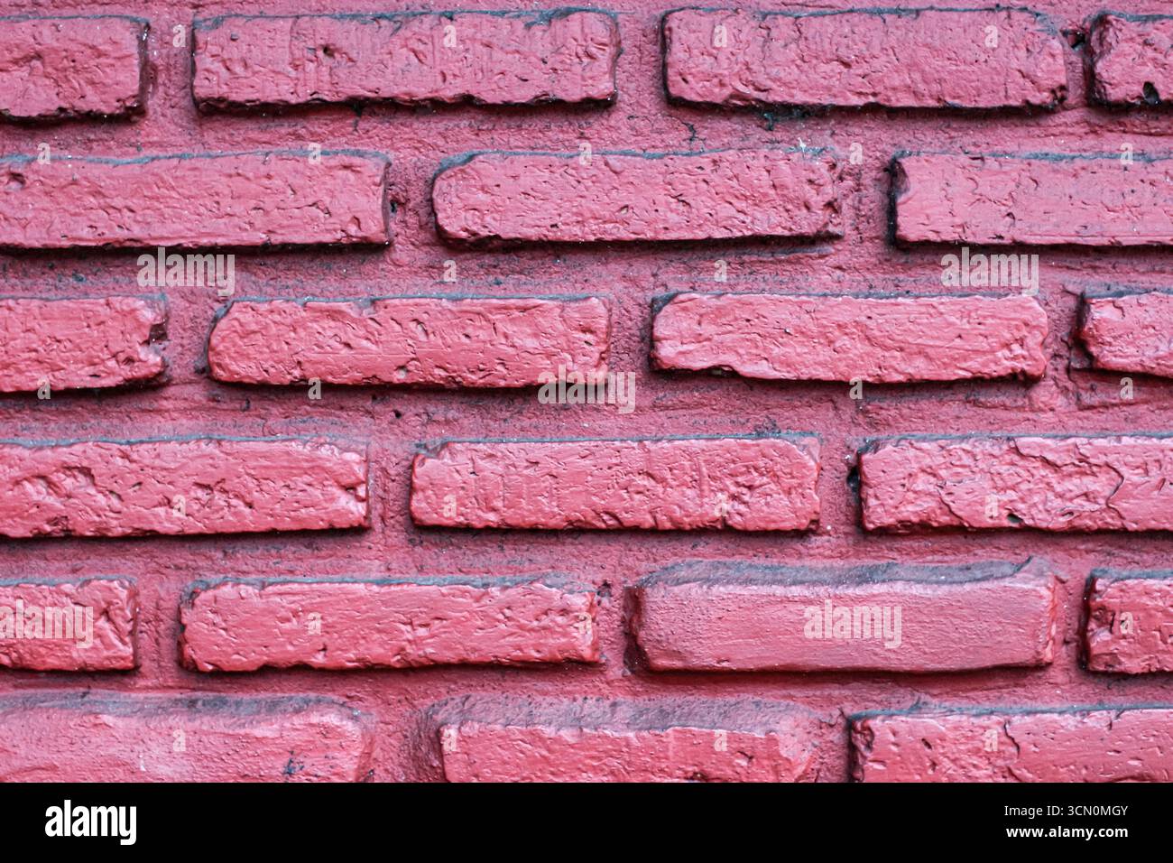 Pink red brick wall with rustic countryside texture, visible mortar lines, and classic abstract background style. Stock Photo