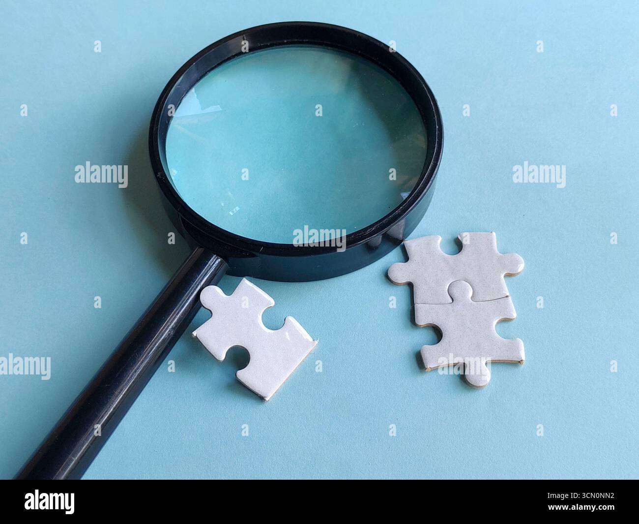 The Magnifying Glass and a Puzzle Stock Photo