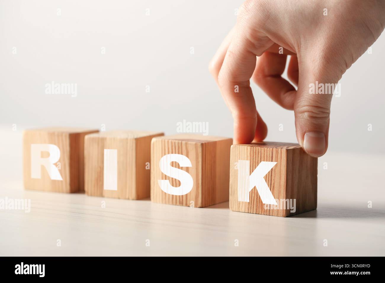 Woman putting wooden cube hi-res stock photography and images - Alamy