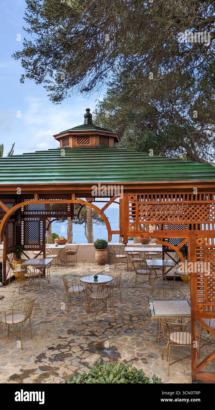 Seaside café with wooden pergola at Cap Spartel Tangier Morocco, overlooking the mediterranean sea - Smartphone Captured Stock Image