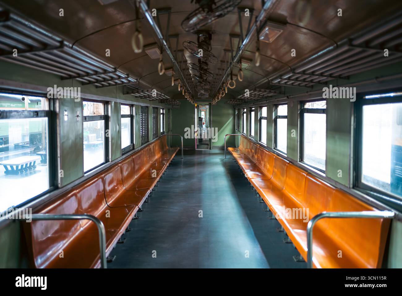 vintage train wagon interior with perspective view, retro carriage in classic design and cozy aged ambiance Stock Photo