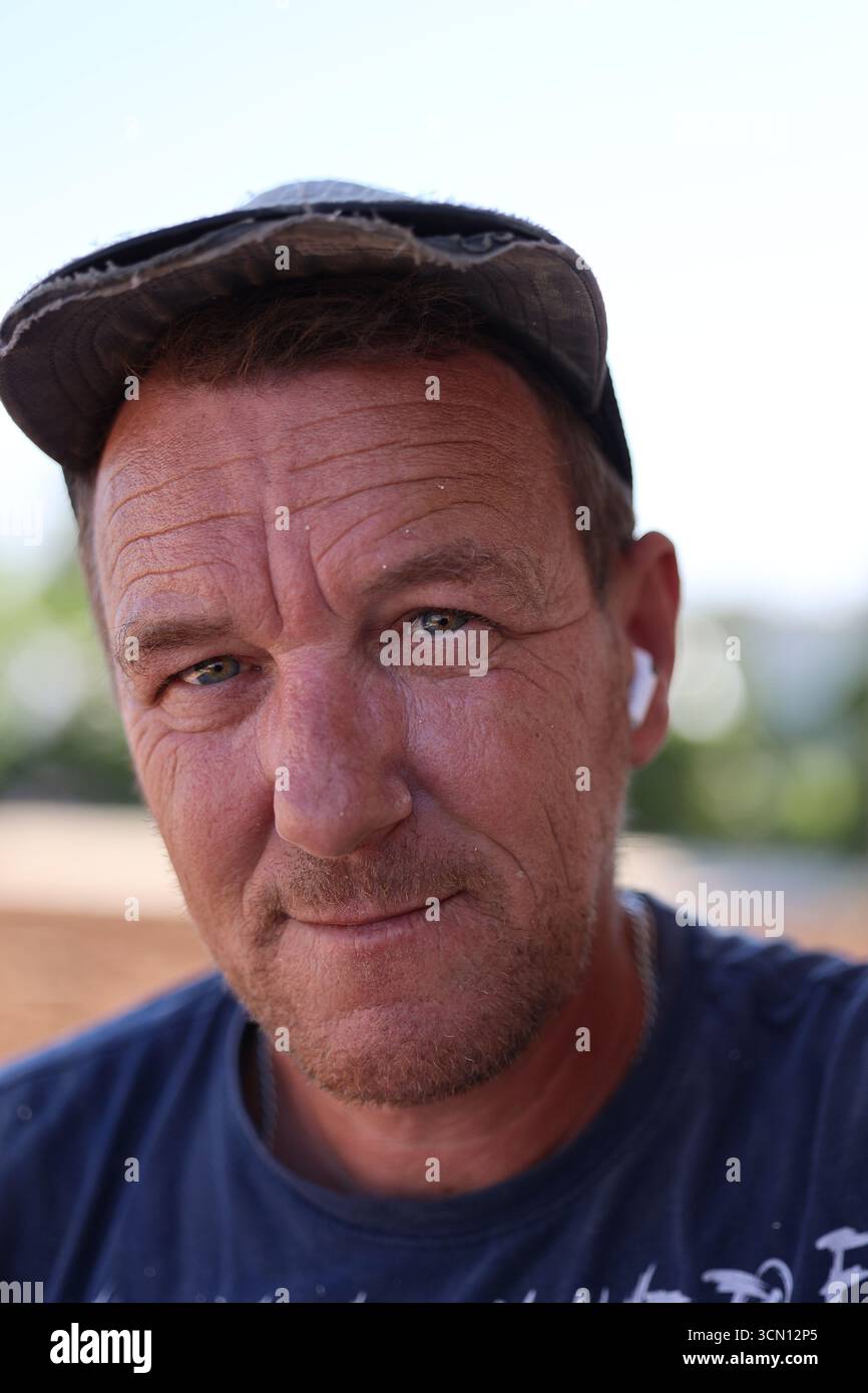 A sincere portrait of a middle-aged man with a thoughtful expression and a smile Stock Photo