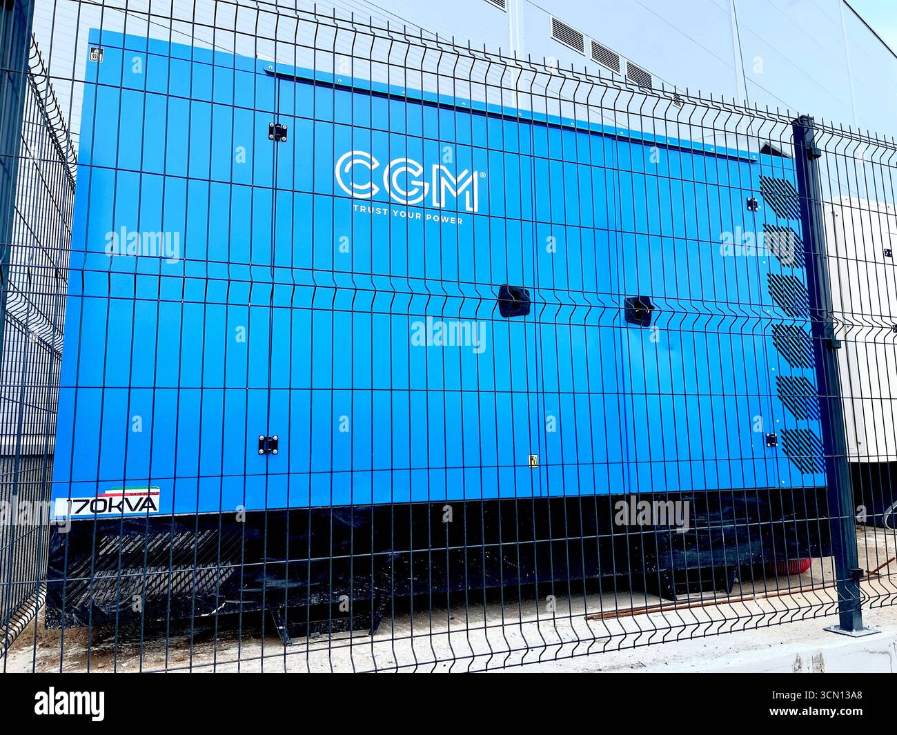 CGM power generator outside a shopping mall centre providing backup electricity and emergency power supply for business retail operations - Smartphone Captured Stock Image