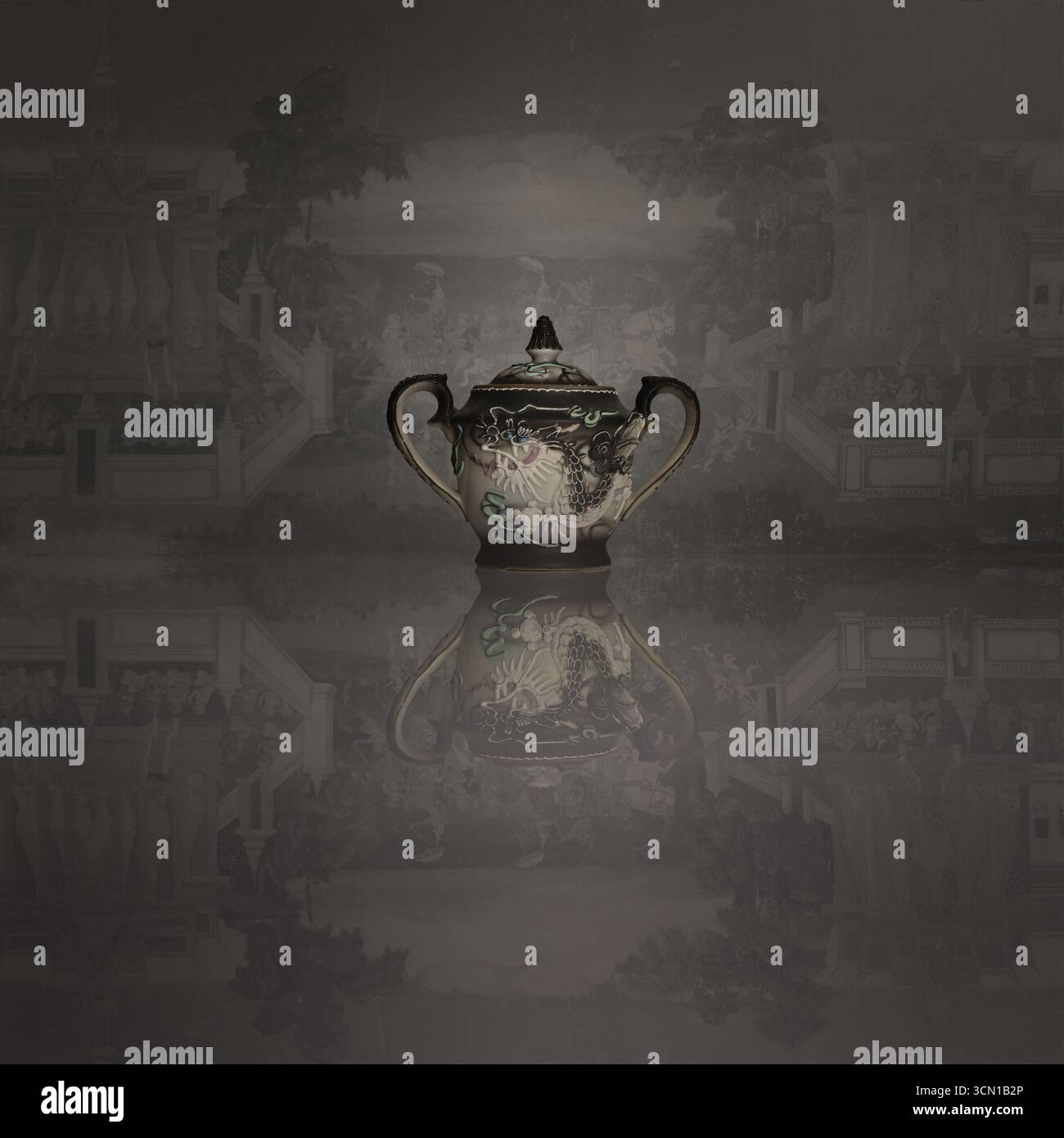 Antique porcelain sugar bowl with dragon motif design and reflection Stock Photo