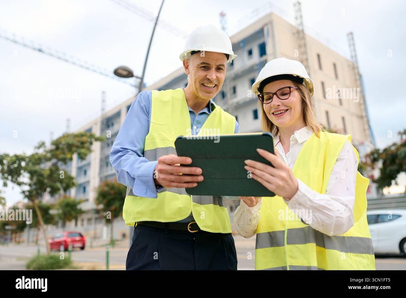 Engineers using tablet planning construction at site Stock Photo