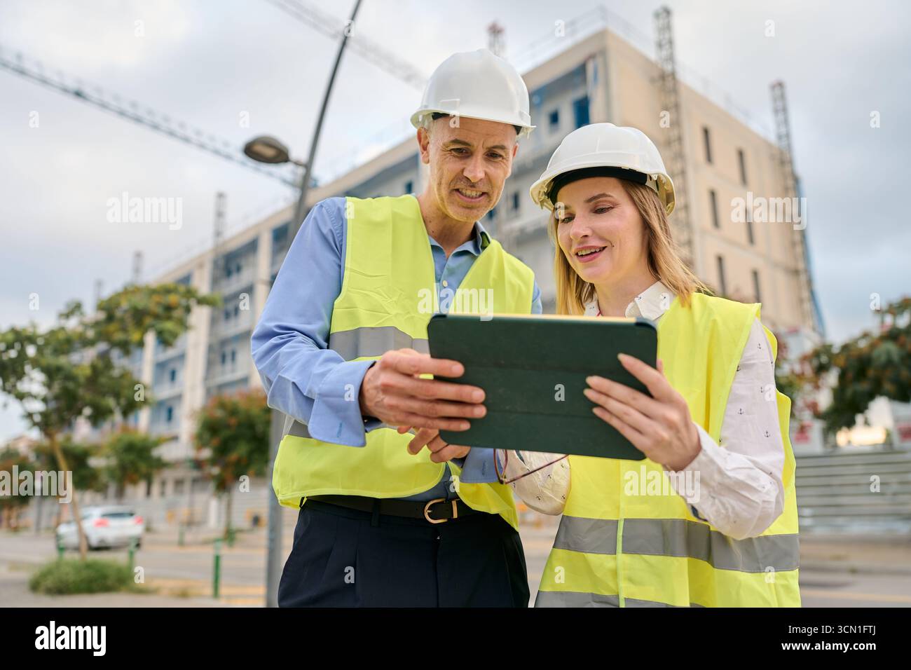 Engineers planning construction project using digital tablet Stock Photo