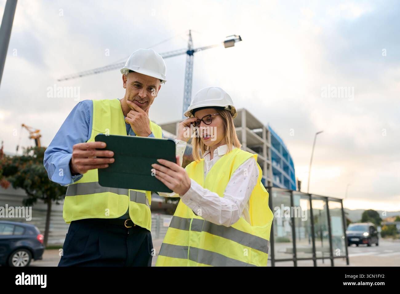 Construction engineers working with tablet on site Stock Photo