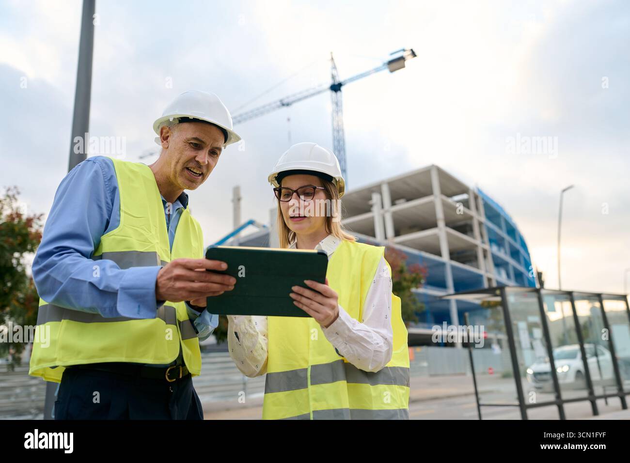Engineers planning construction project using digital tablet Stock Photo