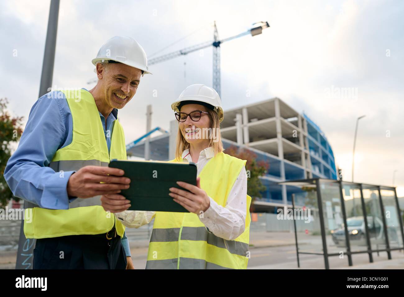 Construction engineers working together using digital tablet Stock Photo