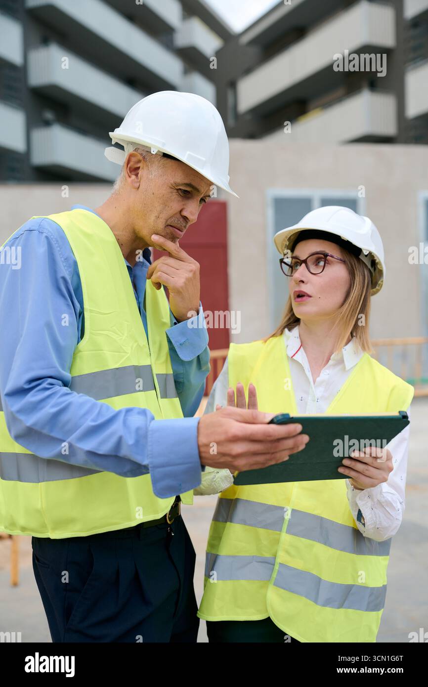 Construction engineers planning project using digital tablet Stock Photo