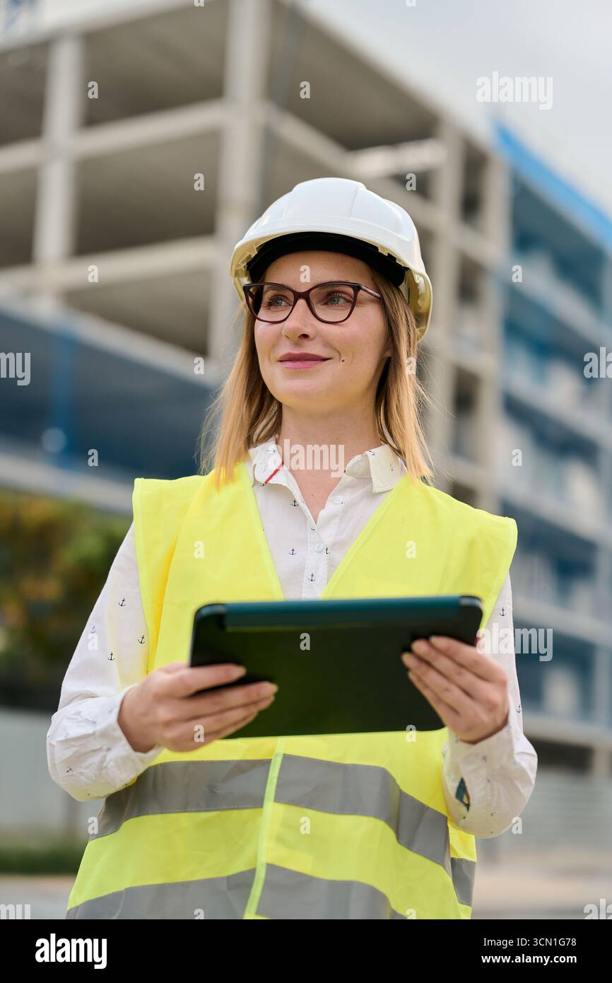 Woman engineer holding tablet working at construction site Stock Photo
