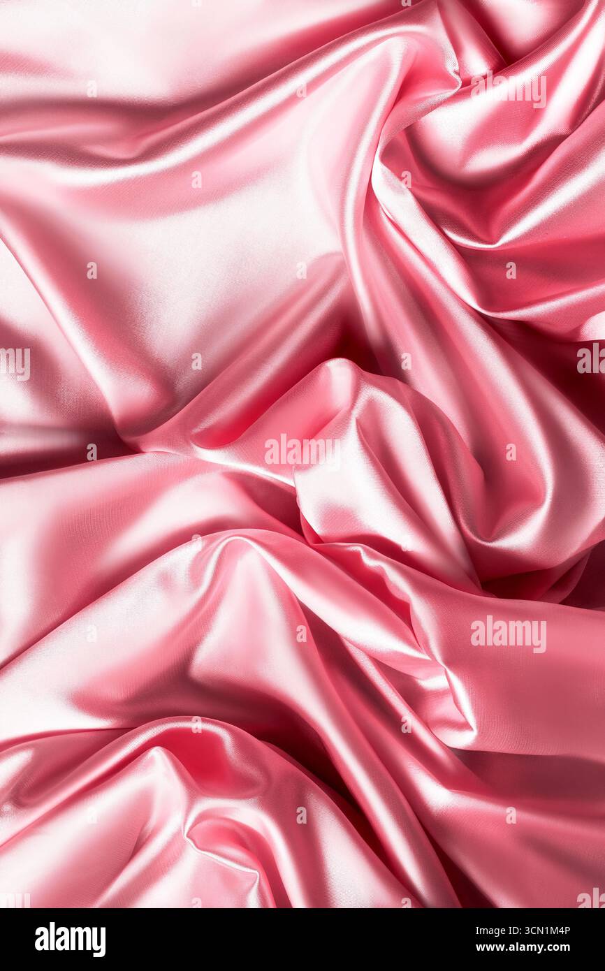 Pastel pink draped satin fabric closeup as a background Stock Photo - Alamy