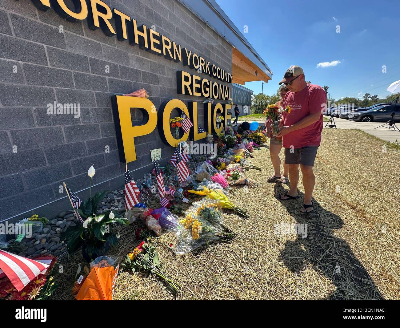 A memorial for police officers killed in a shooting is shown outside ...
