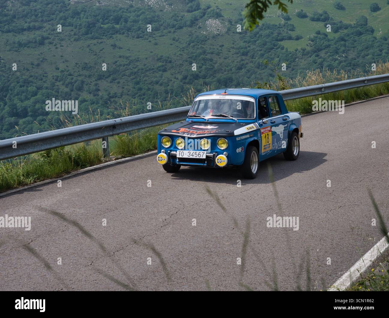 Vibrant Blue Rally Car in Action - A vintage blue Renault 8 rally car ...