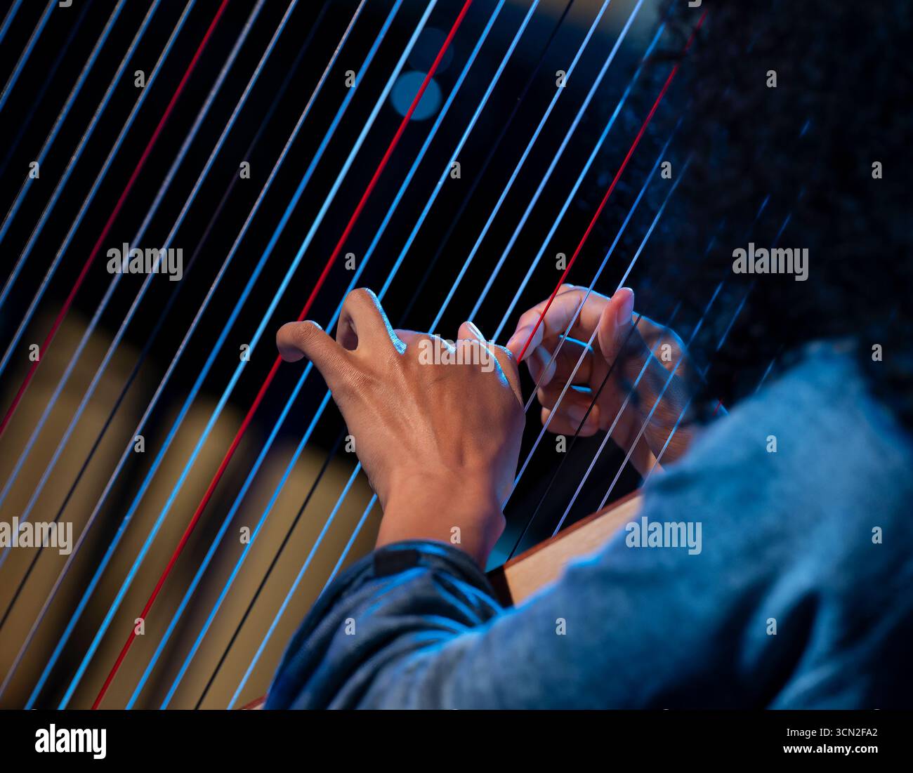 Hand playing on harp Stock Photo