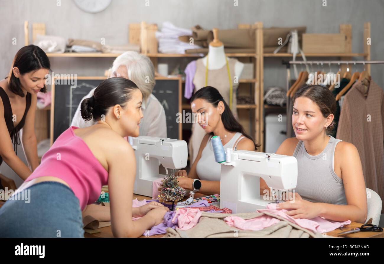 Multigenerational group of women enjoying sewing class in workshop Stock Photo