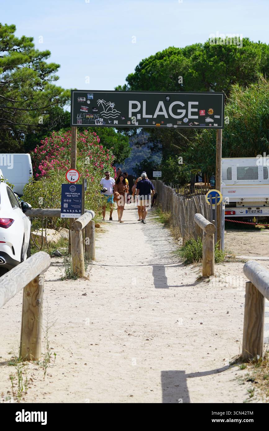Beach Entrance Sign With Pathway And Group Of Tourists Walking Toward ...