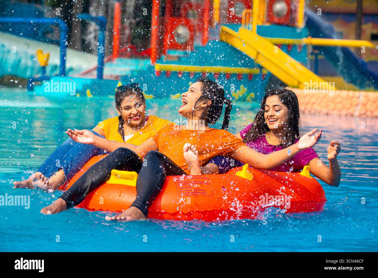 A Diverse Group of Friends Laughing and Splashing as They Float Down a ...