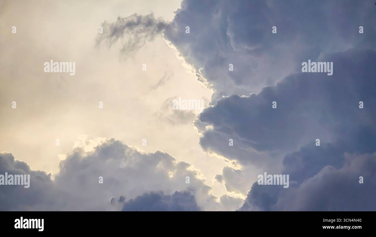 Blue sky with clouds, thunderclouds, summer weather. Sunset. White clouds. Rain. Stock Photo