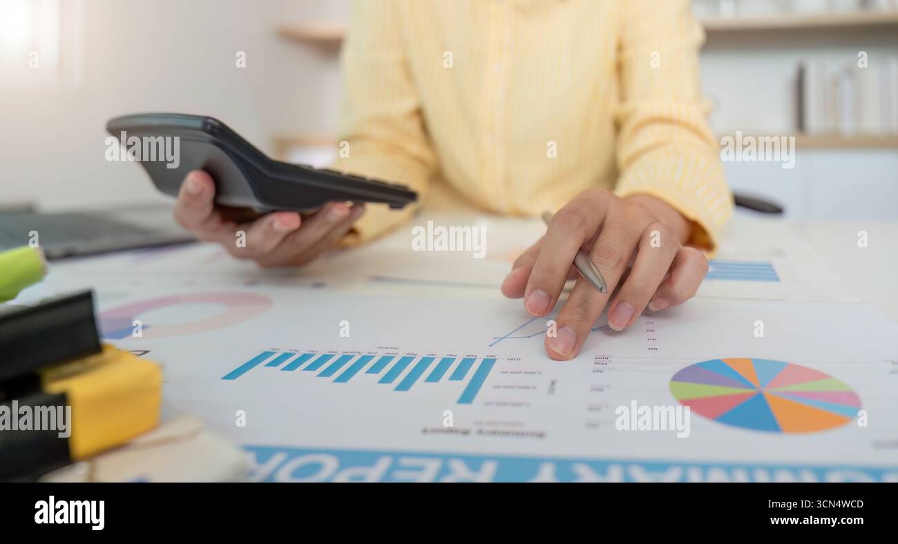 Financial Analysis. Professional analyzing data with calculator and reports. Stock Photo