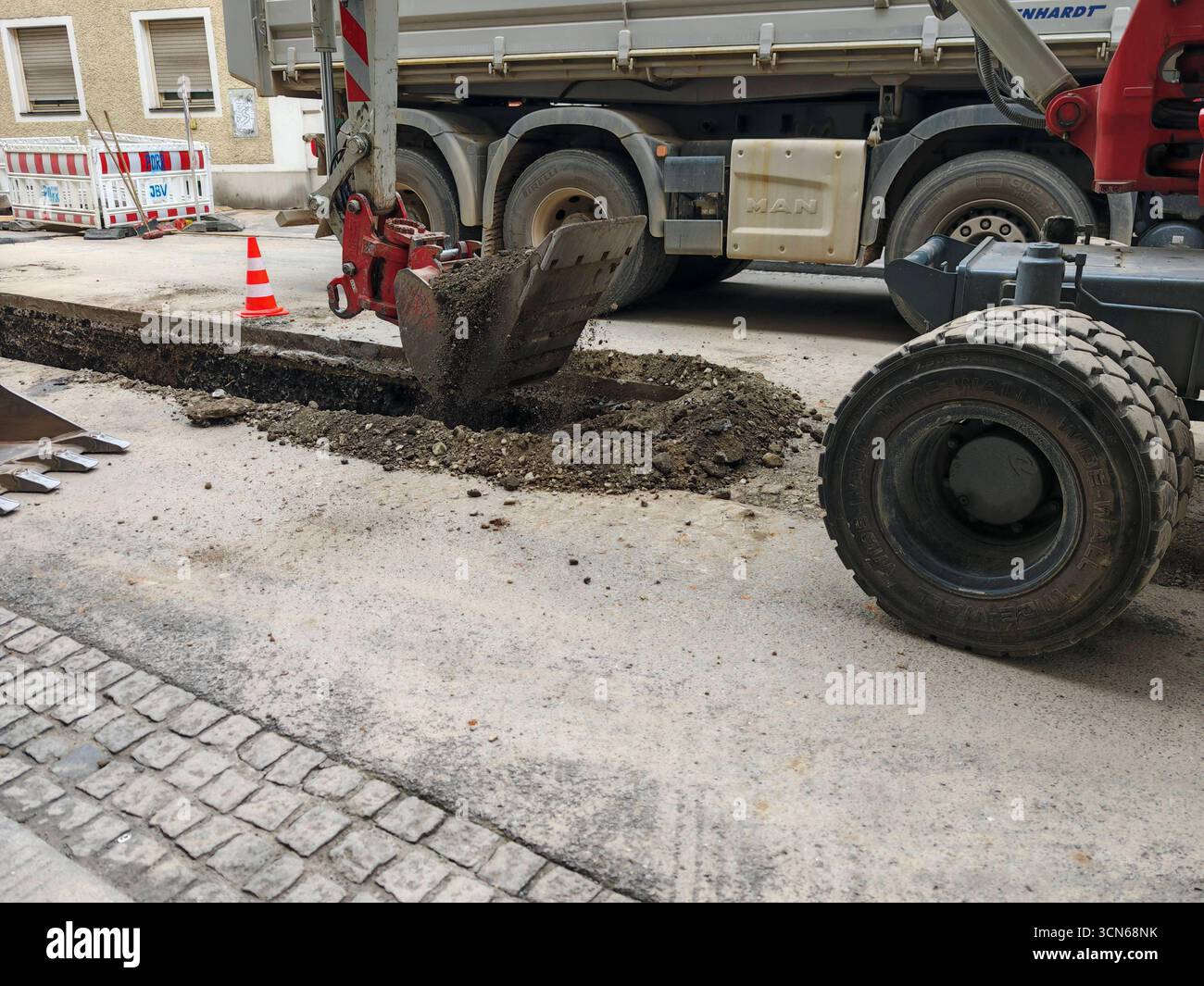 regulating a water stream with an excavator for flood control ...