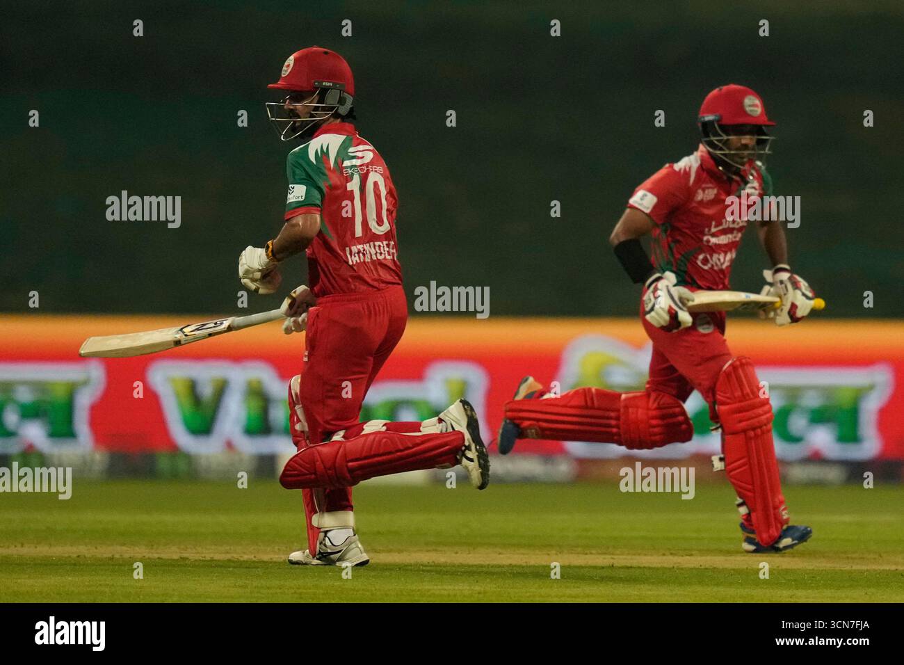 Oman's Captain Jatinder Singh, left, and Oman's Aamir Kaleem run ...