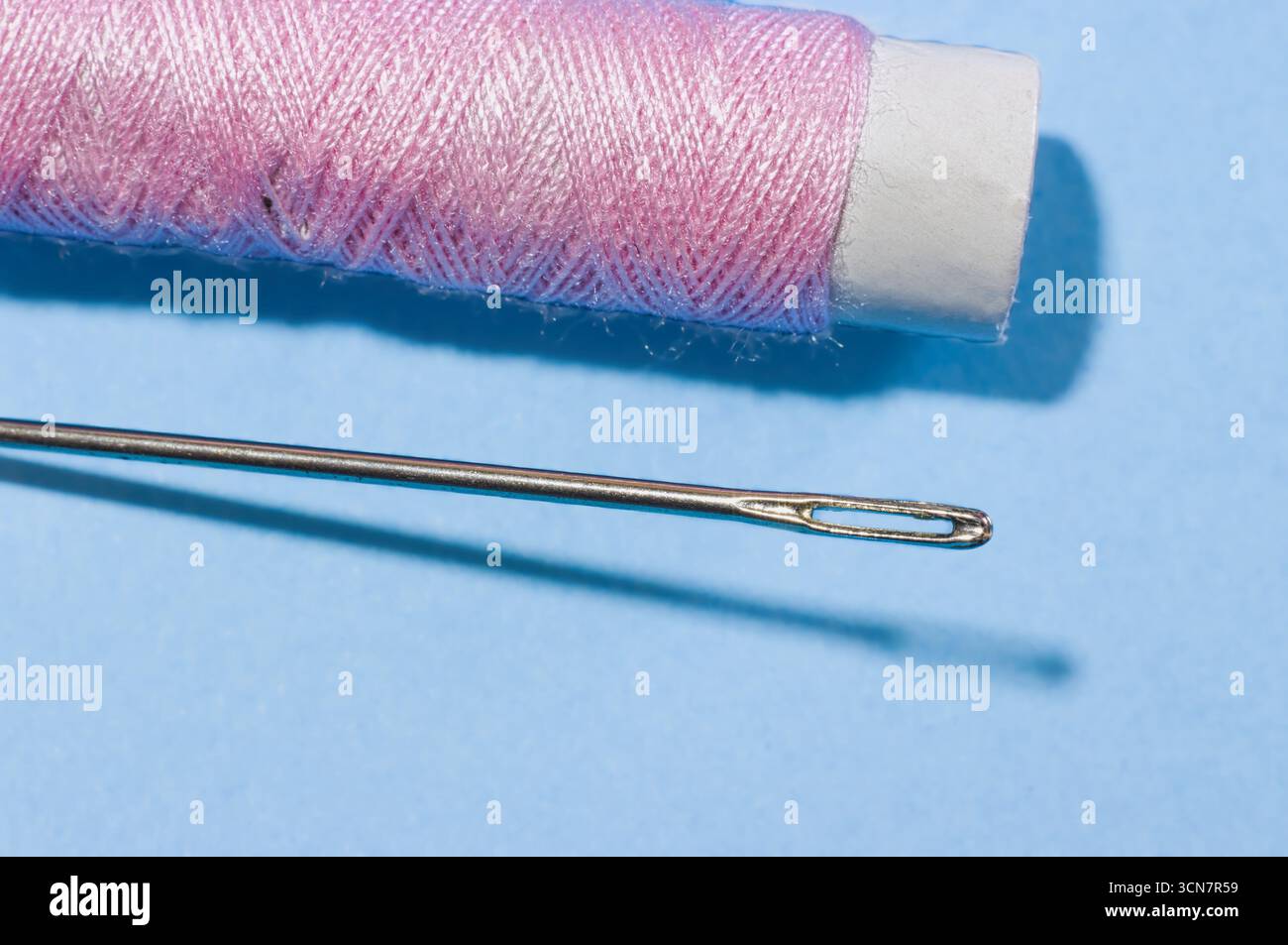 Sewing needles, thread, scissors, and thimbles. Stock Photo