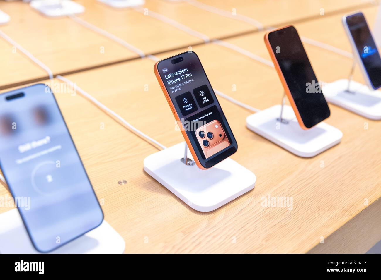 Apple employees help customers at the Fifth Avenue Apple Store on new ...