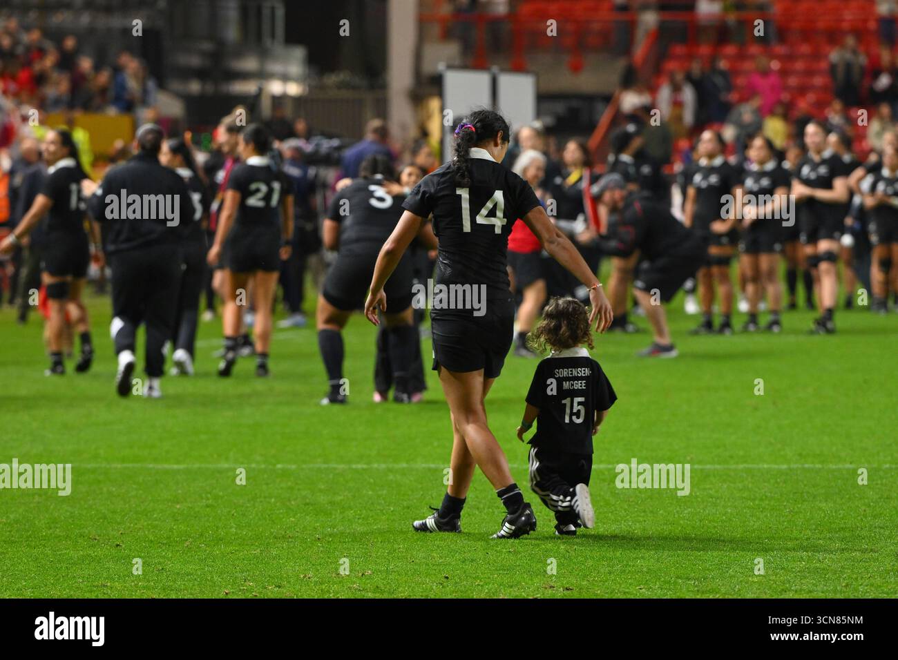 New Zealand's Braxton Sorensen-McGee walks with a child after the Women ...