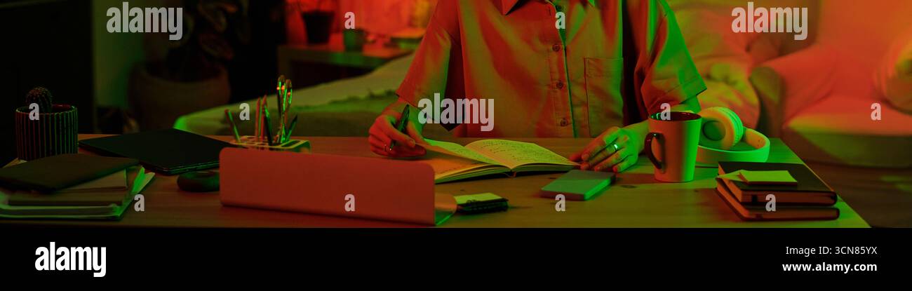 Woman Studying at Desk with Laptop and Books Indoors Stock Photo