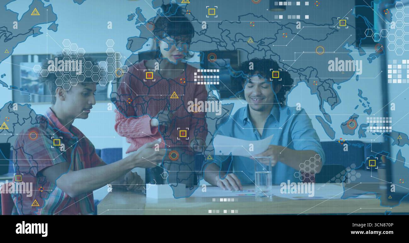 Collaborating tech professionals examining prototype, reviewing docs in office with overlay Stock Photo
