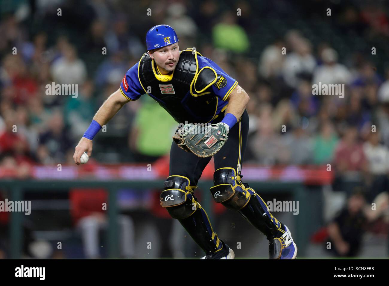 Seattle Mariners catcher Cal Raleigh throws to first fielding a bunt ...