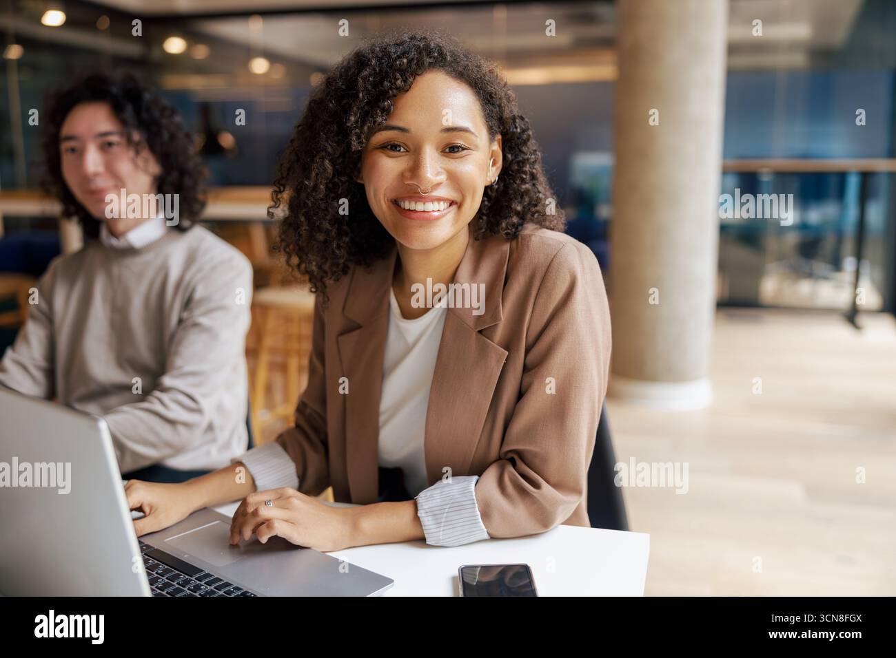 Young Professionals Themed Modern Office Collaborating and Engaging in Creative Tasks Together Stock Photo
