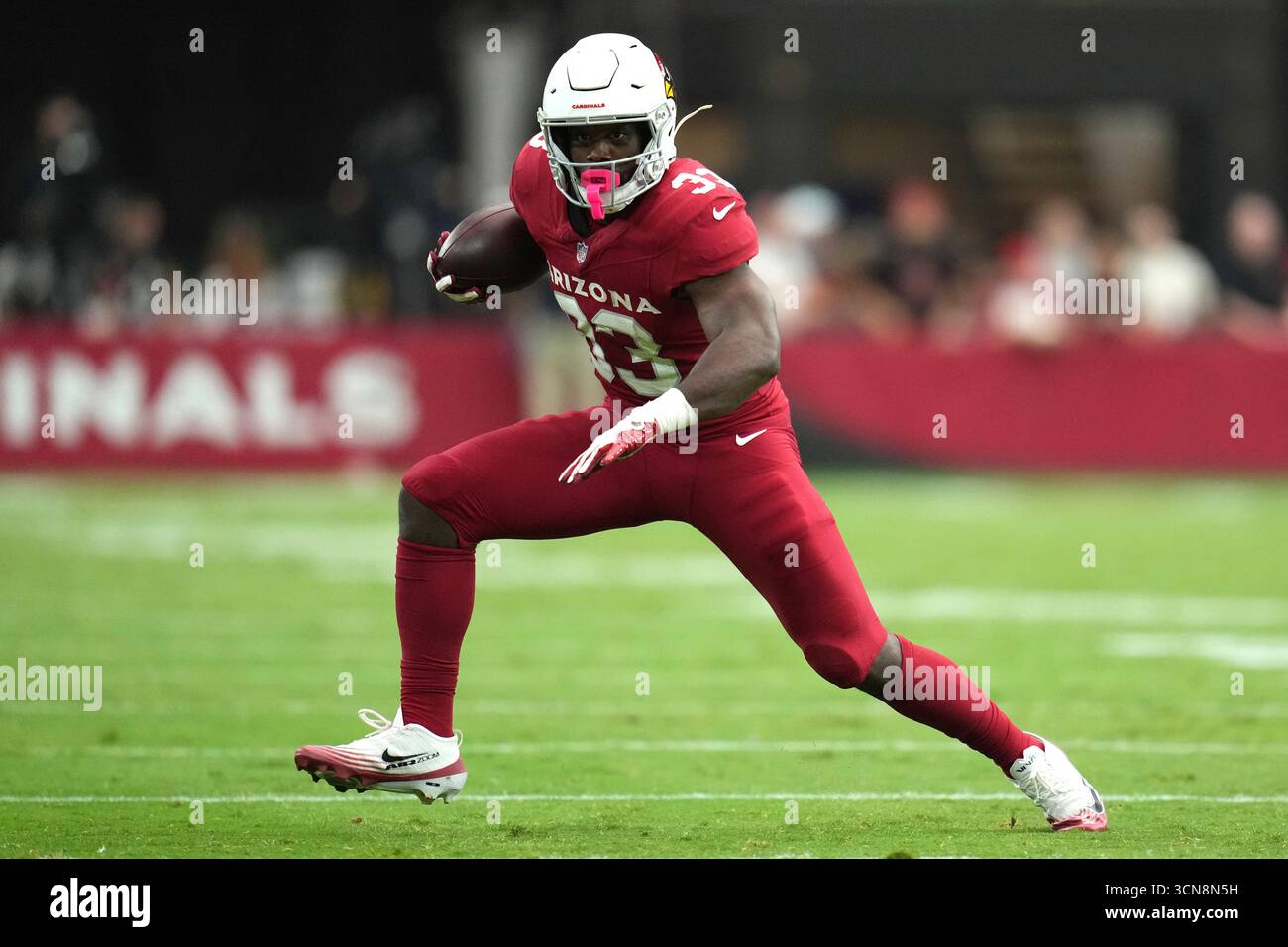 Arizona Cardinals running back Trey Benson (33) runs the ball against ...
