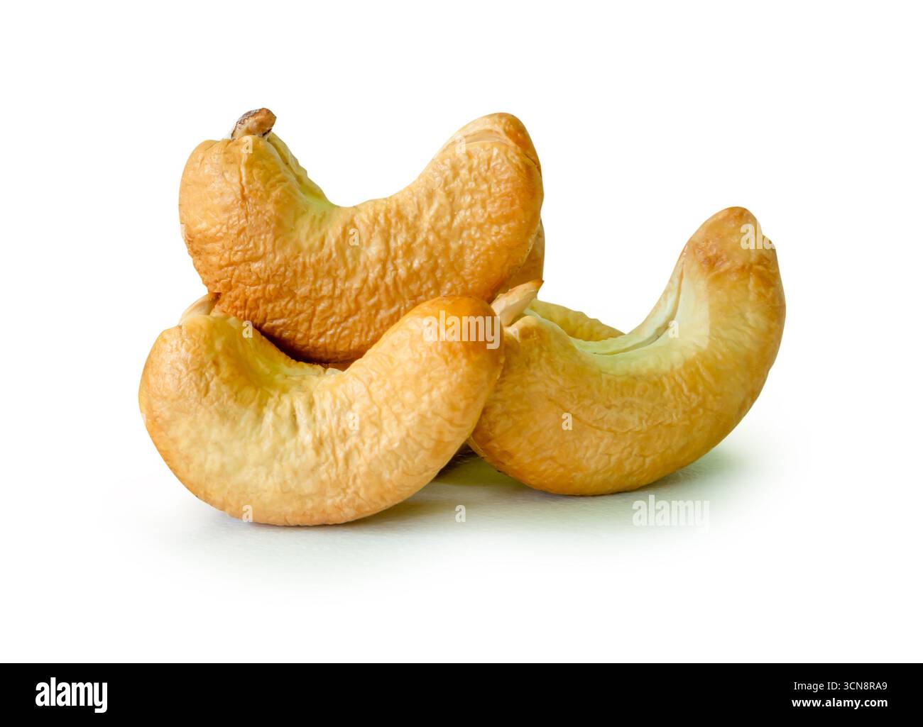 Roasted peeled cashew nuts in stack are isolated on white background with clipping path. Stock Photo