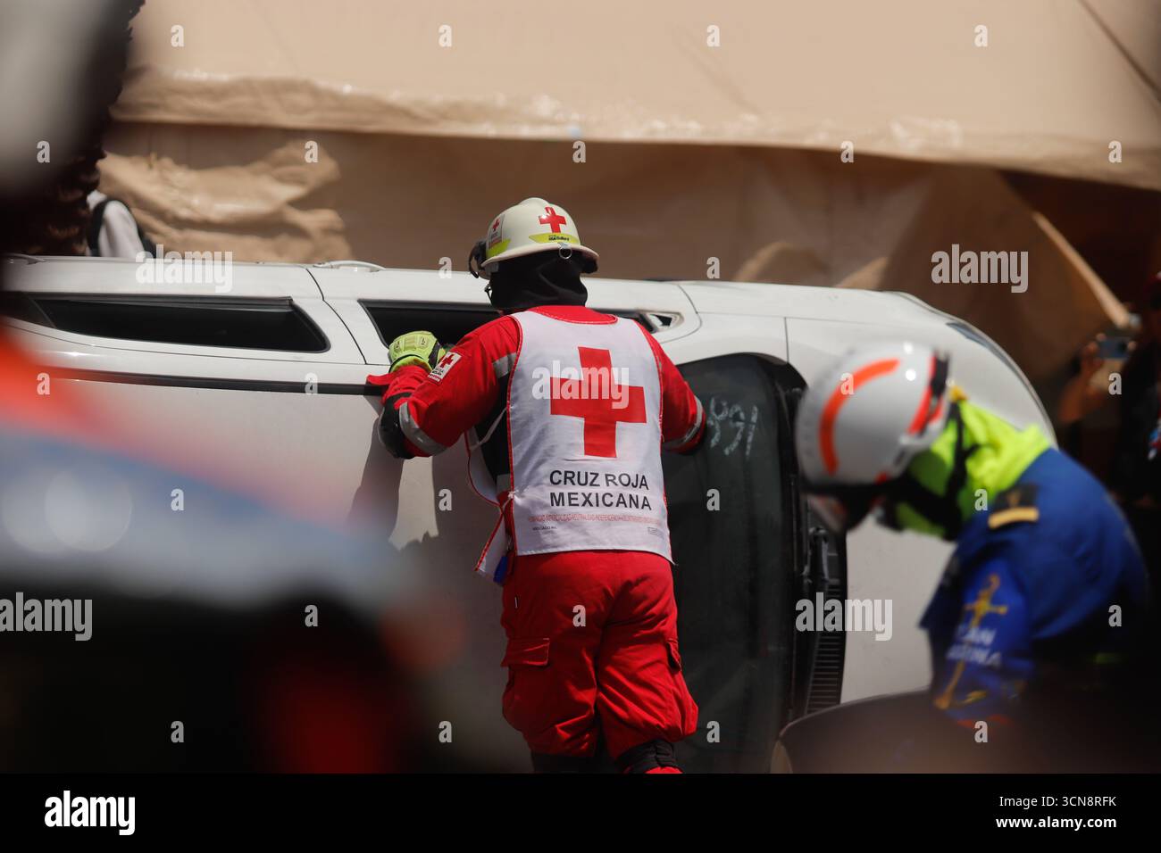 Red cross rescuers simulate the rescue of a person trapped in a car ...
