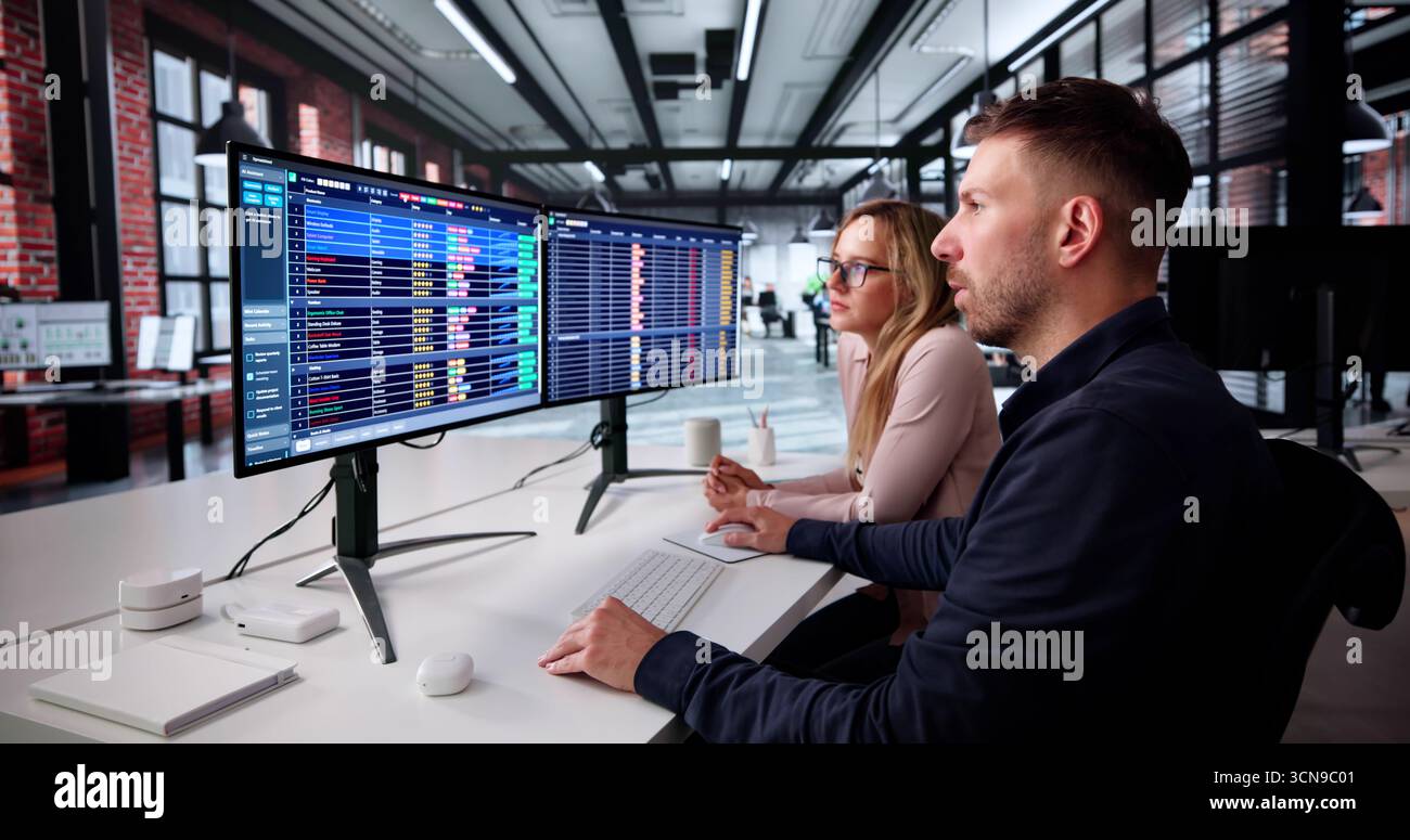 Data Analyst Analyzing Spreadsheets On Computer In Medical Office Setting. Stock Photo