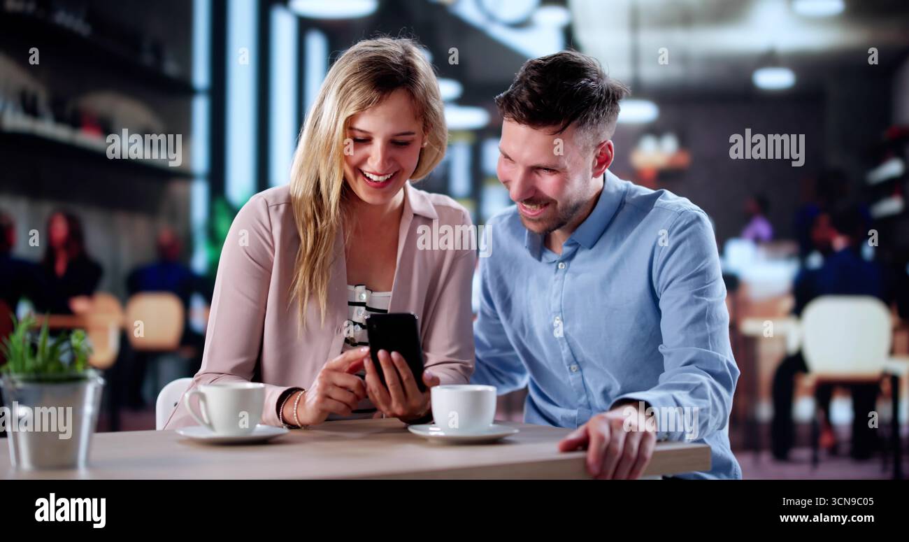 Multicultural Couple Having A Great Time At A Cafe Together. Stock Photo